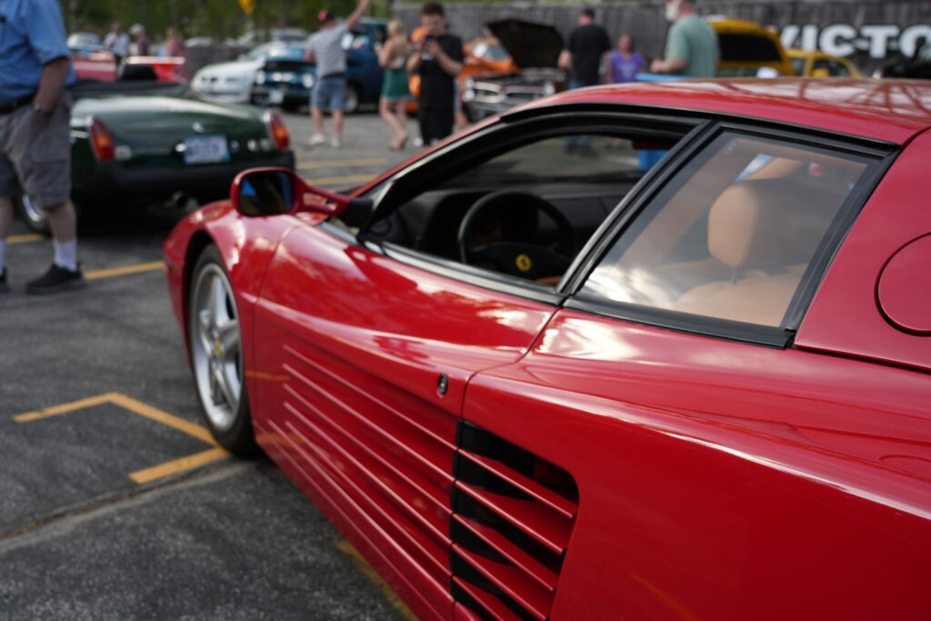 The side strakes and rear haunch of a red Ferrari Testarossa