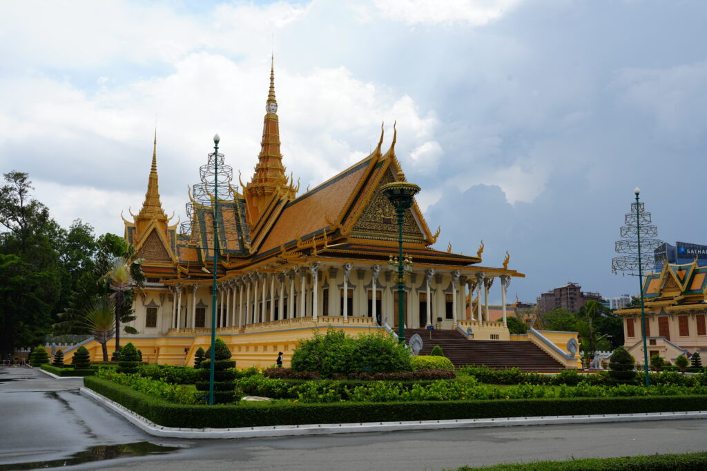 The gilded Throne Hall of the Royal Palace under a grey monsoon sky