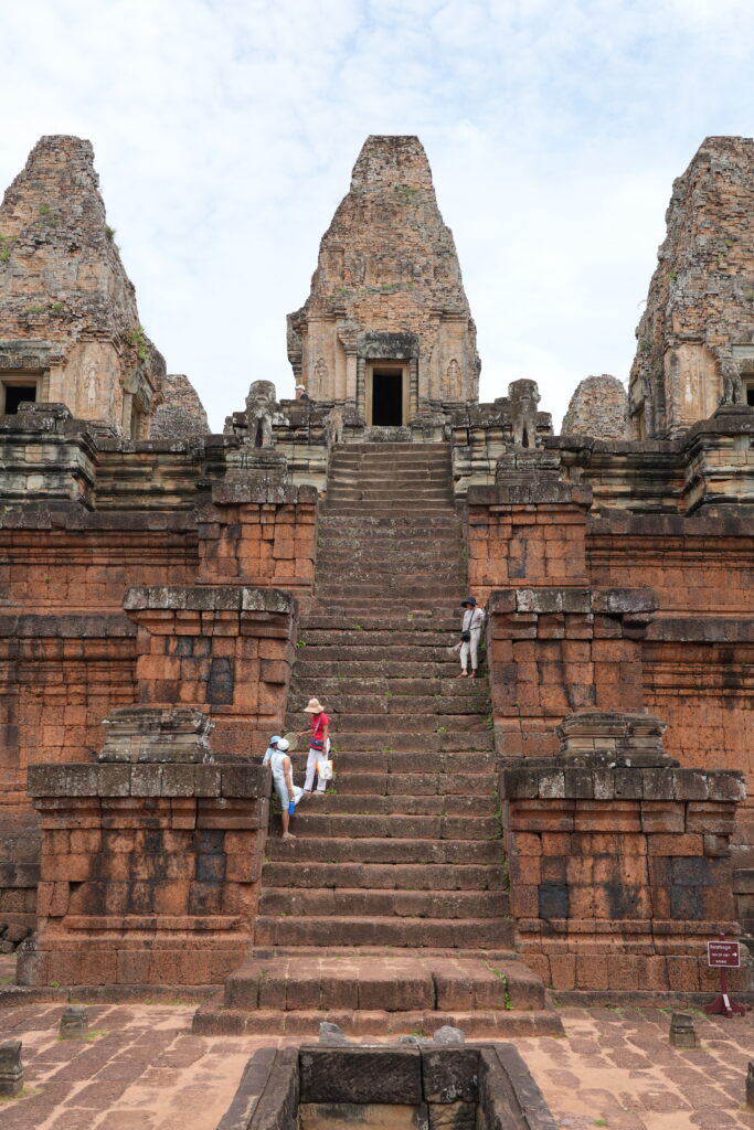 Visitors climbing the steep laterite stairway of Pre Rup temple