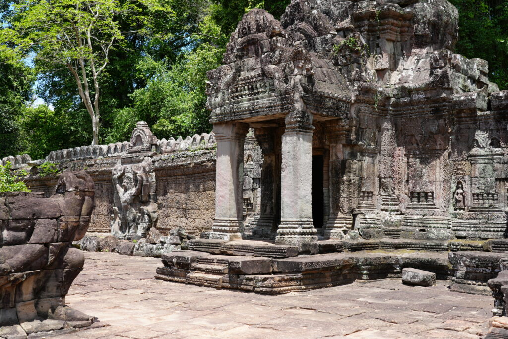 Columned stone pavilion and carved gallery at Preah Khan