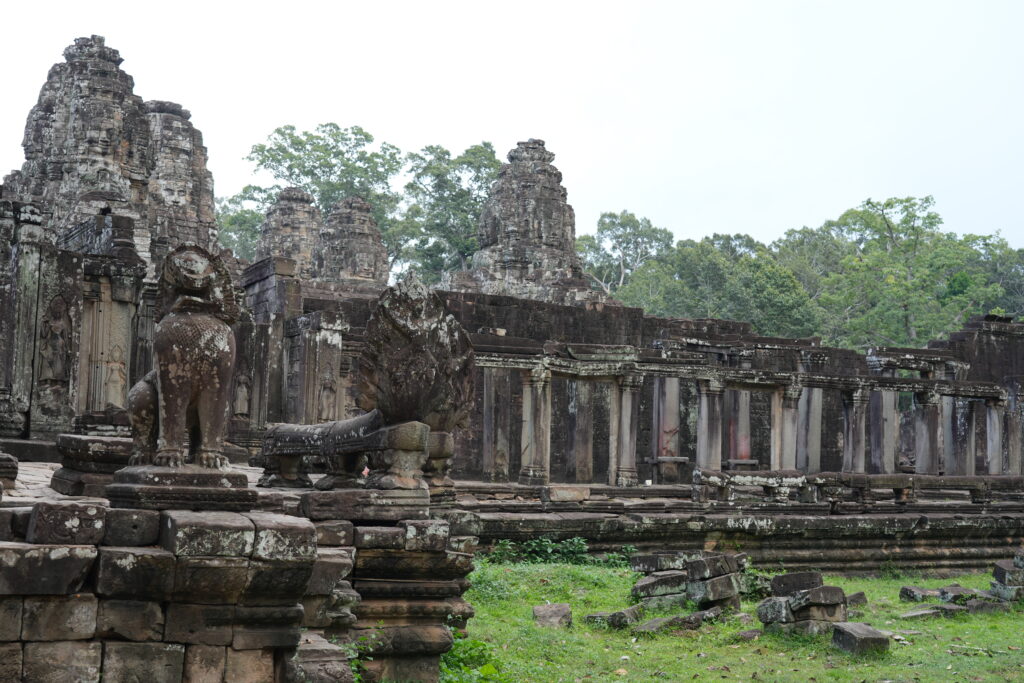 A carved stone elephant at the corner of a temple terrace