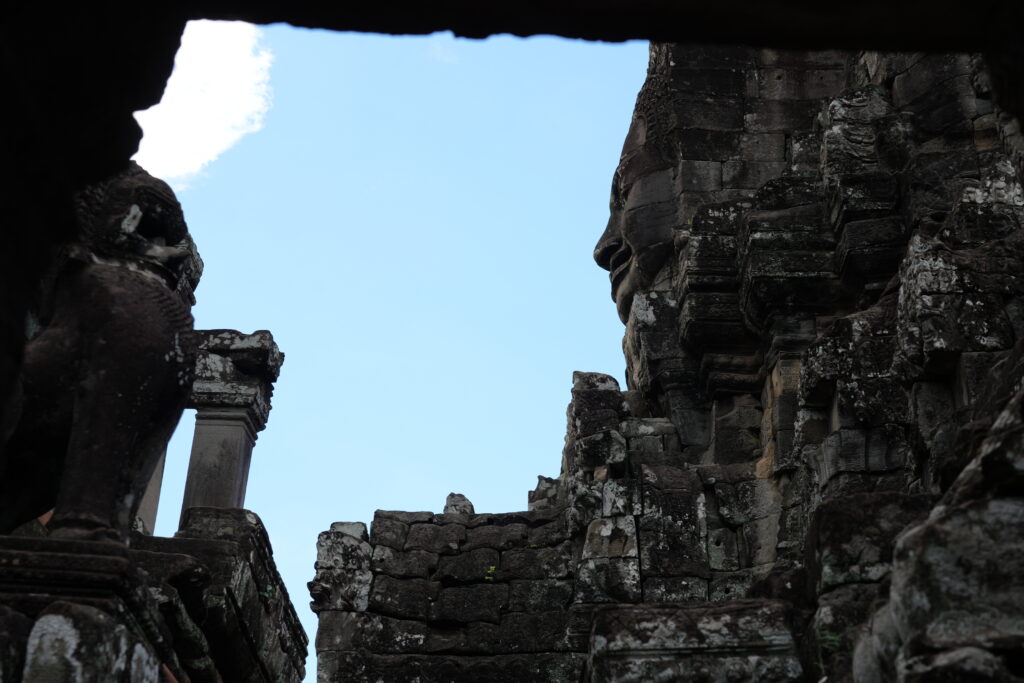 Bayon's towers framed by a dark stone window opening