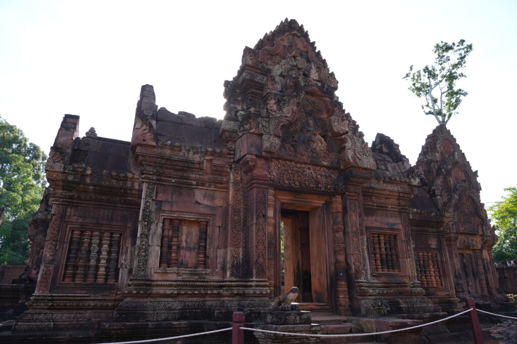 The rose sandstone facade and carved pediments of Banteay Srei