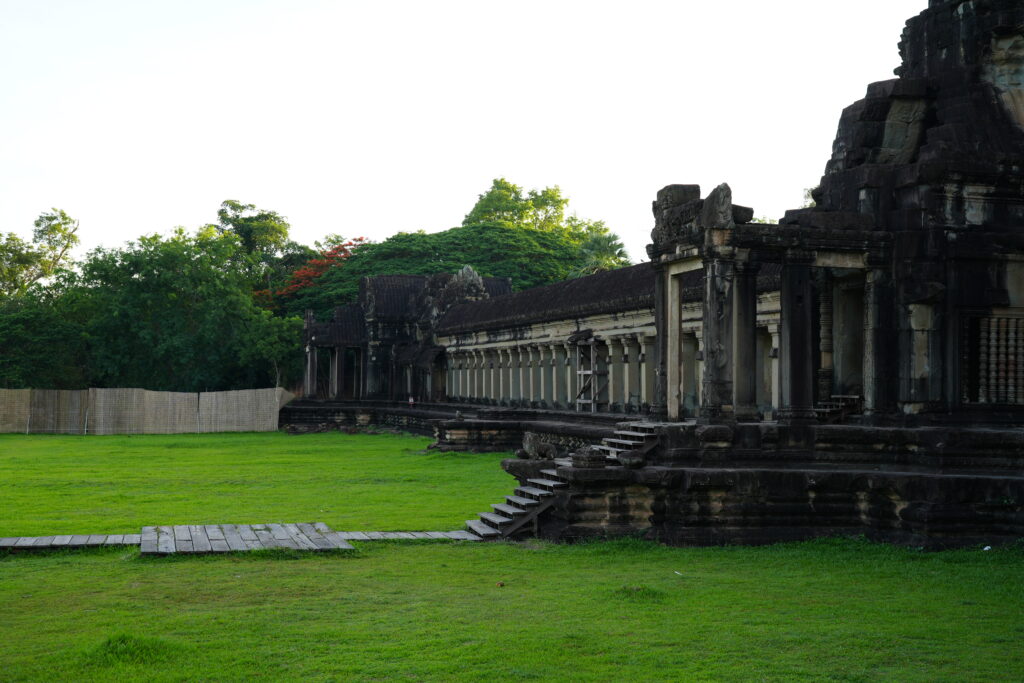 Angkor Wat's outer gallery and lawn under early morning sun