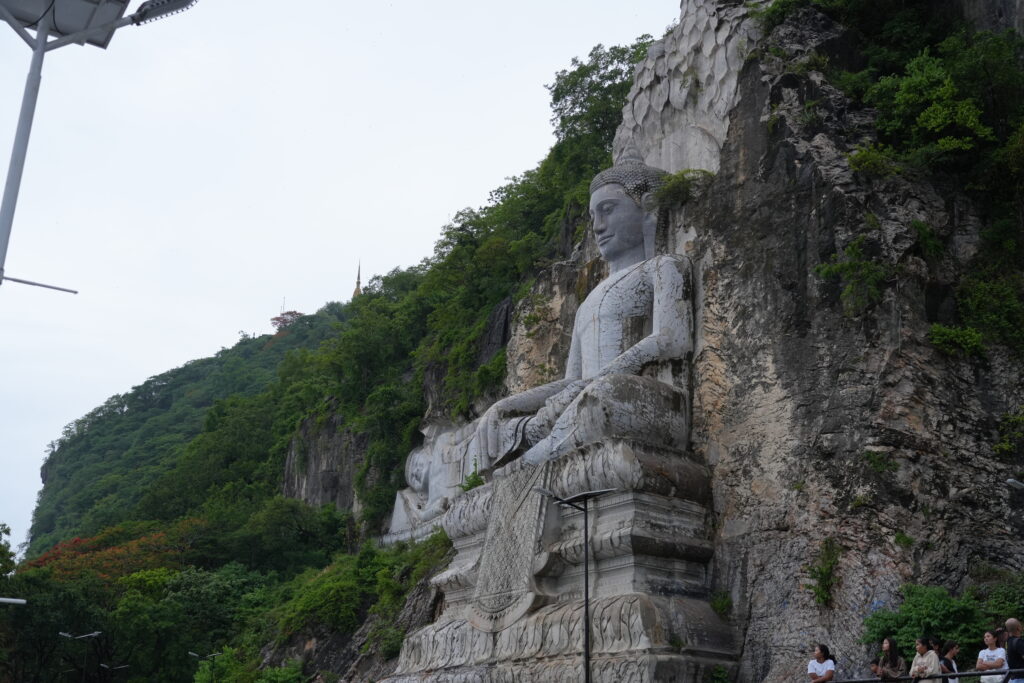 Giant carved Buddha in limestone cliff