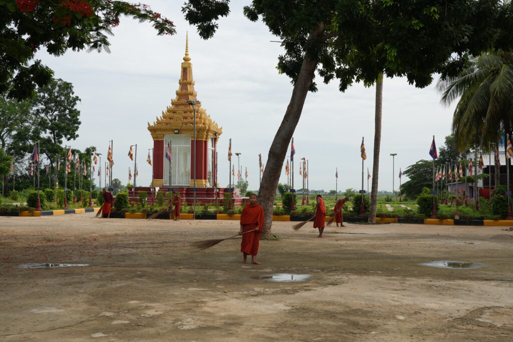 Young monks sweeping temple grounds