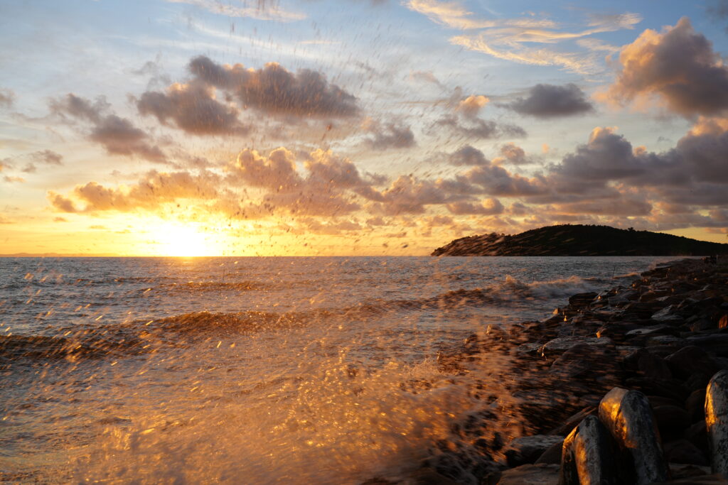 Backlit sea spray at sunset