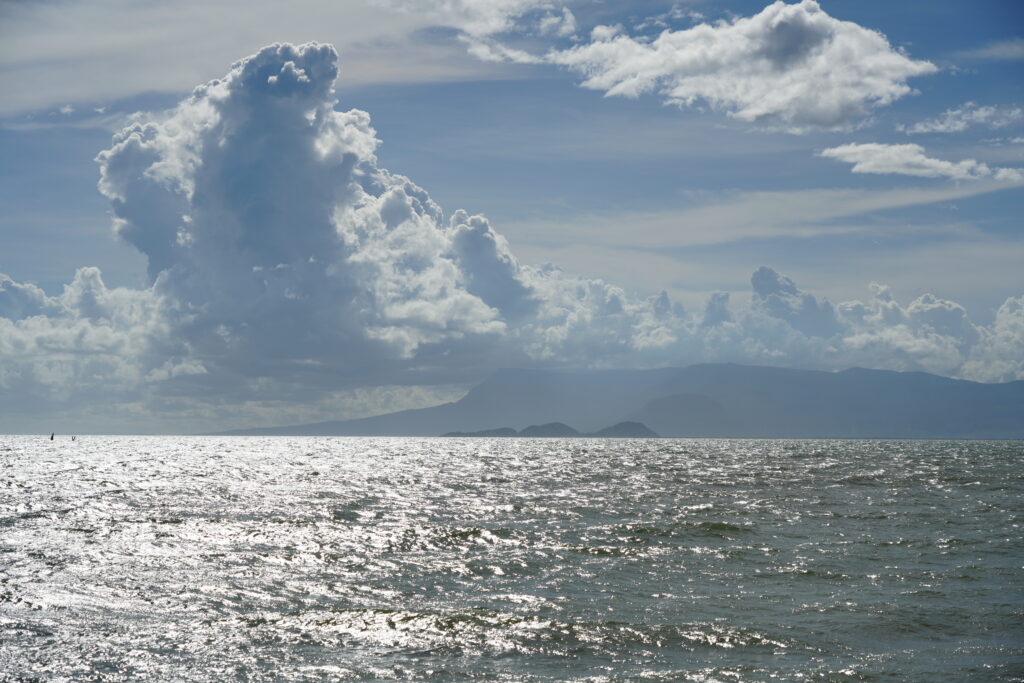 Backlit sea and towering cumulus