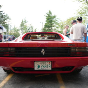 Rear deck and tail lights of a red Ferrari Testarossa at a car show