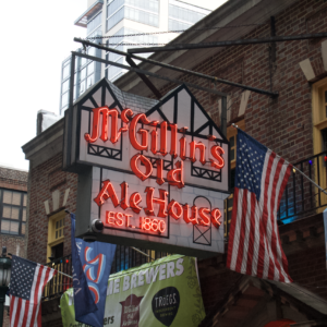 Historic McGillin's Olde Ale House sign and American flags, Philadelphia