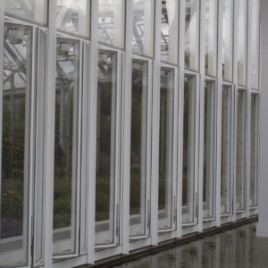 Repeating white steel mullions and glass panels of a conservatory wall