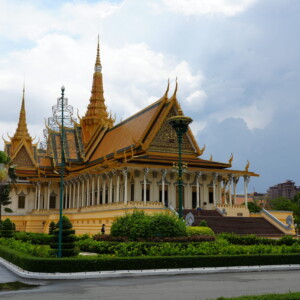 The gilded Throne Hall of the Royal Palace under a grey monsoon sky