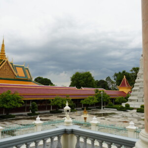 Royal Palace stupas and rooflines seen past a marble column