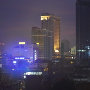 City towers glowing through humid haze at nightfall