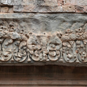 An intricately carved sandstone lintel of scrollwork and figures