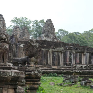 A carved stone elephant at the corner of a temple terrace