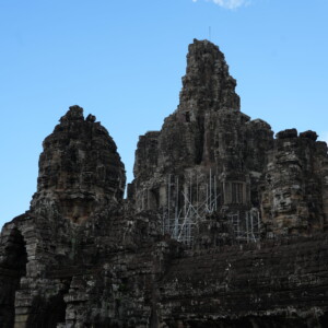 The clustered face towers of Bayon temple against blue sky