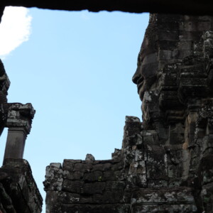 Bayon's towers framed by a dark stone window opening