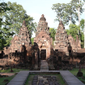 The pink sandstone towers of Banteay Srei framed by forest