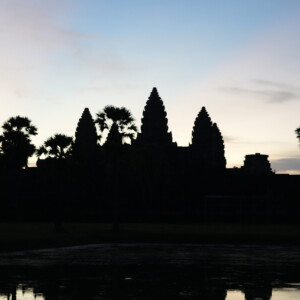 Angkor Wat in silhouette mirrored in the still reflecting pool