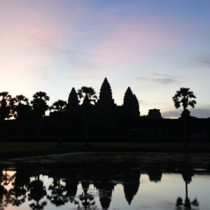 Pink dawn clouds over Angkor Wat reflected in the lotus pool